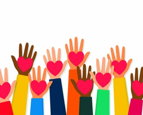 Charity, volunteering and donating concept. Raised up human hands with red hearts. Children's hands are holding heart symbols