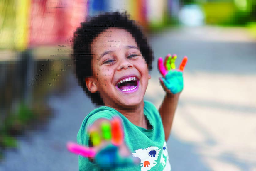 beautiful happy boy with painted hands