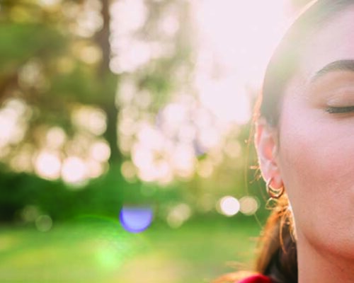 Relaxed woman breathing fresh air outdoors